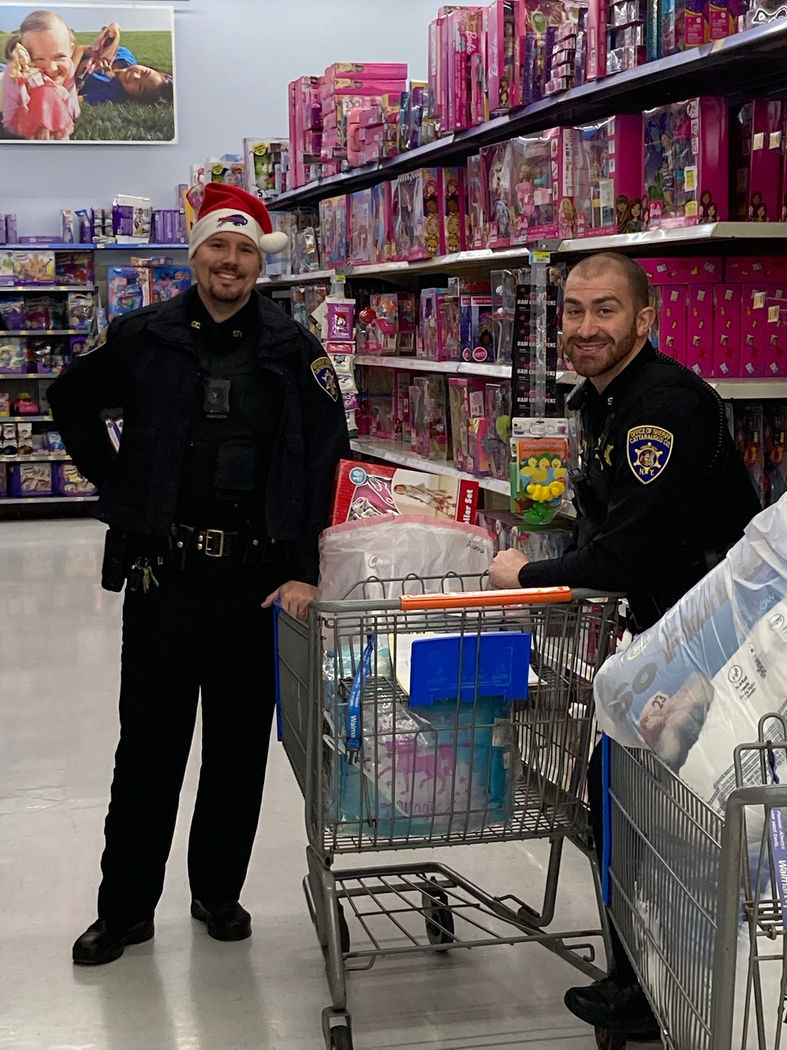Deputy Steven Dombek and Deputy Kale Luce filling their shopping carts for Santa Sheriff families.